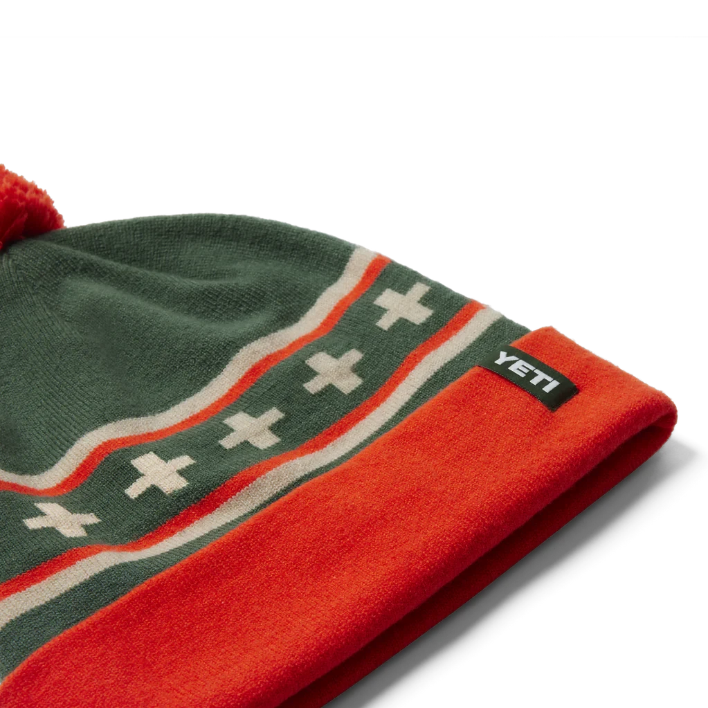 YETI "Pom Beanie" -Traeger Pellet Grills 21023007320 230139 site studio 2H24 Fall Apparel HATS SYETIPOMBeanie Green Orange ANGLE1 068 Primary B 2400x2400 f2445f0c 6674 40ce 914f a84a58a8eae9